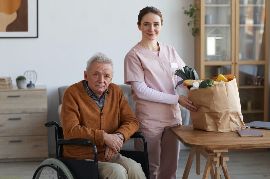 Portrait of Disabled Senior Man with Female Caregiver