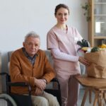 Portrait of Disabled Senior Man with Female Caregiver