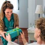 Senior patient giving a gift to her doctor